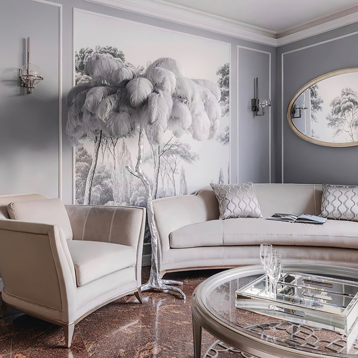 Pale grey plumes spread over a Clérachic floor lamp in a grey sitting room, set against a tree-print mural beside a cream sofa.
