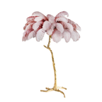 Blush plumes with rose-tipped edges on a Clérachic floor lamp with a polished brass stem, shown on white.
