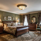 A Clérachic flush ceiling light glowing above a sleigh bed in a green-panelled bedroom, with a patterned rug and dark wood furniture.