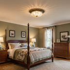 A Clérachic flush mount light lit warm over a four-poster bed in a sage-green bedroom with a chest of drawers and sheer curtains.