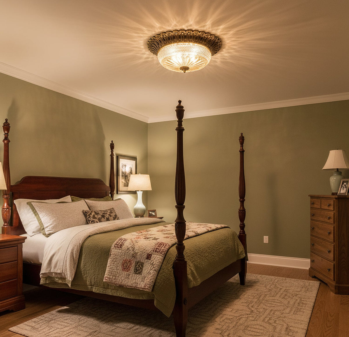 Clérachic flush mount light glowing on the ceiling of a sage-green bedroom, with a patchwork quilt on a dark wood four-poster bed.