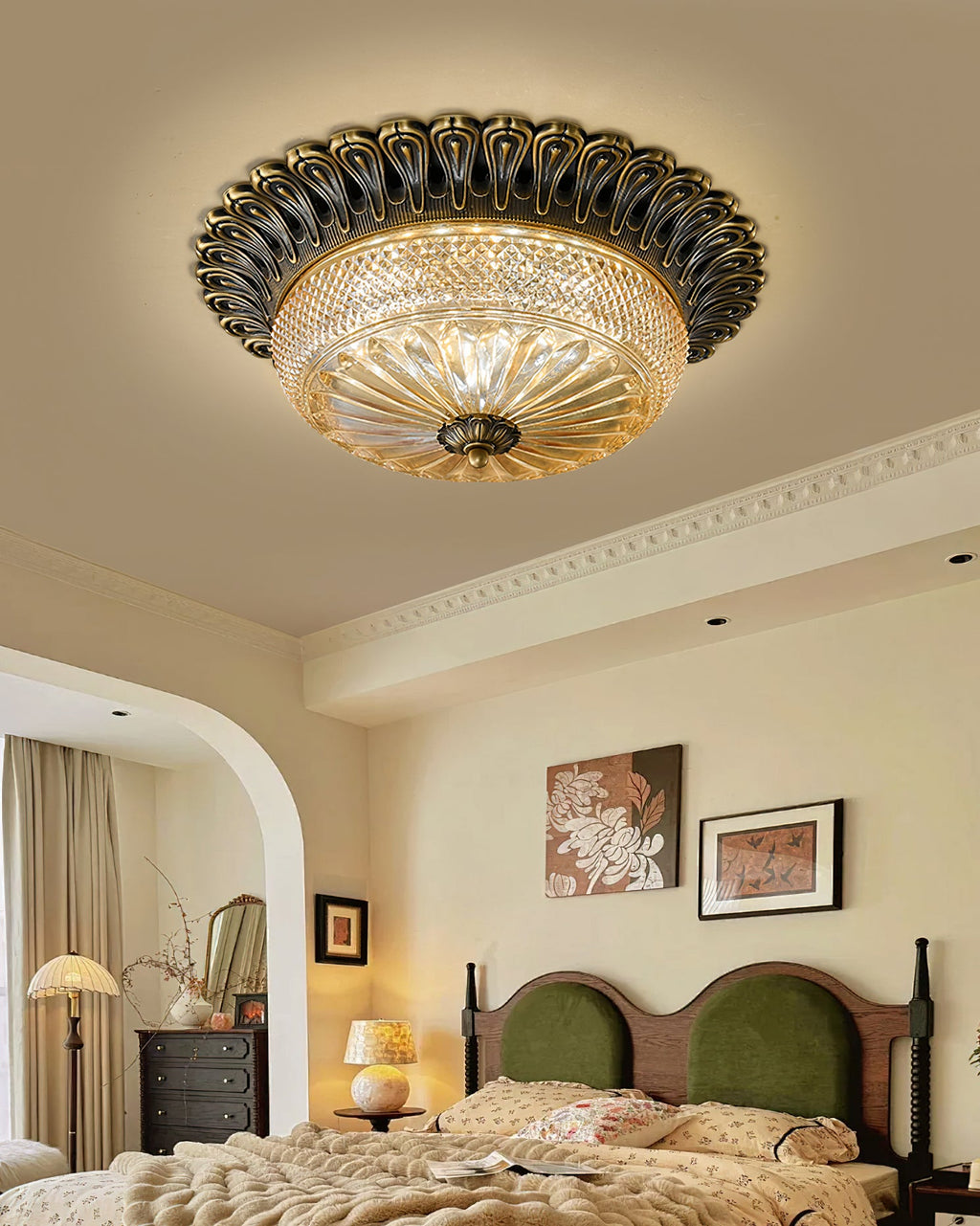This Clérachic ceiling light in an arched cream bedroom, above a bed with a green velvet headboard and a floor lamp beside it.