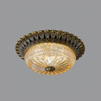 Clérachic flush mount ceiling light in antique brass with an amber glass bowl, photographed on a plain mid-grey backdrop.