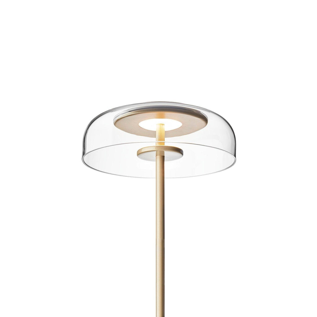 Brass-toned Clérachic table lamp with a clear dome on a white background, with the glass bowl and the inner light ring in close view.