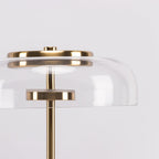 Close view of the unlit glass dome with its brass cap and the small brass disc that holds the LED in this Clérachic table lamp.