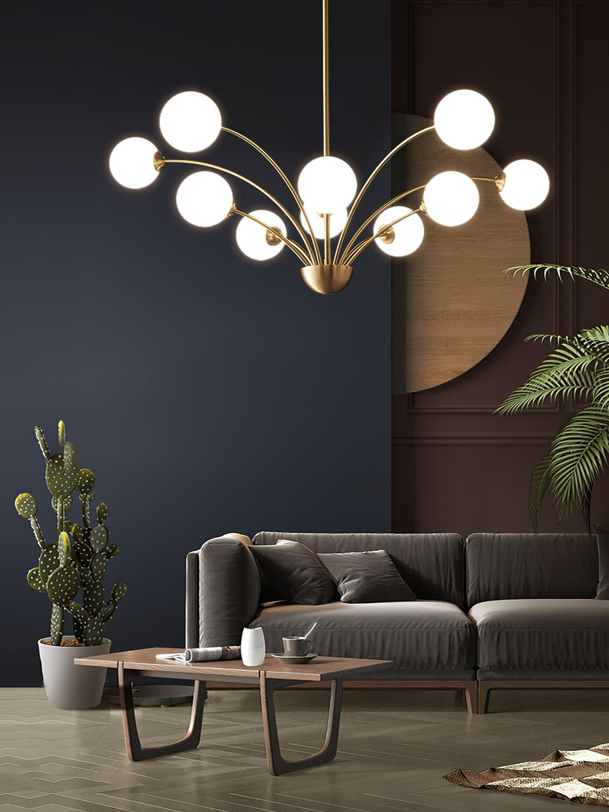 A Clérachic chandelier with white glass globes above a grey sofa and a low walnut table, with a plant and cactus at either side.