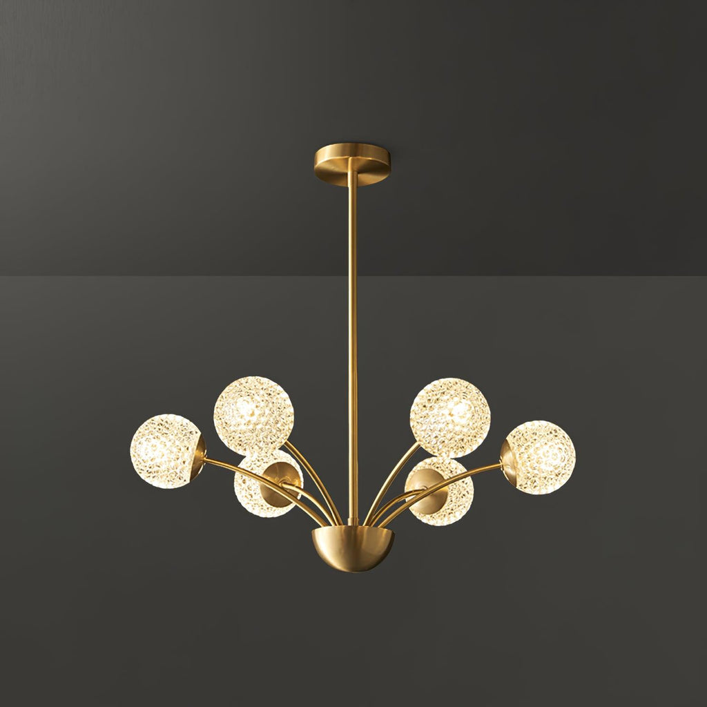 A Clérachic brass chandelier with six textured, honeycomb-pattern globes lit warmly against a dark grey backdrop.