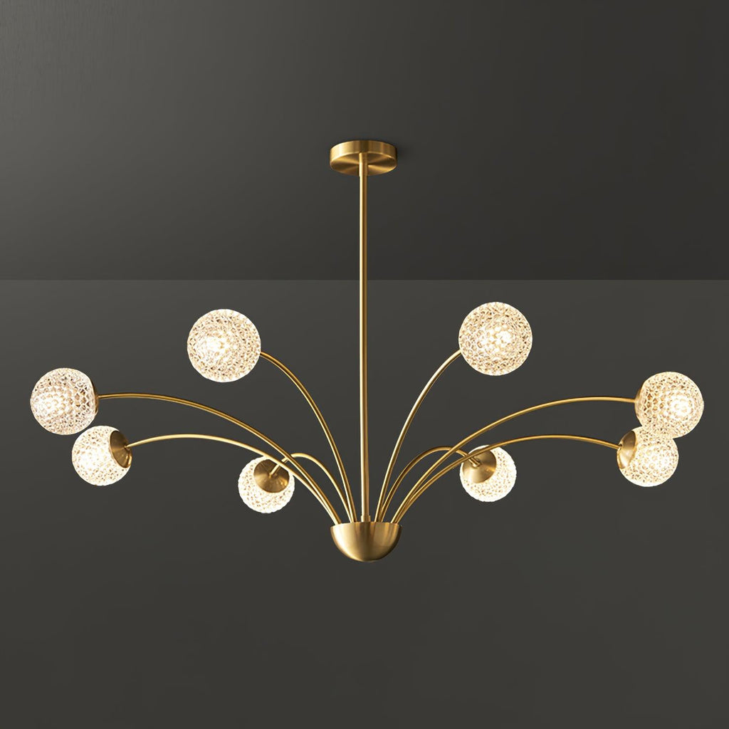 A Clérachic brass chandelier with textured globes on long sweeping arms, photographed against a dark grey backdrop.
