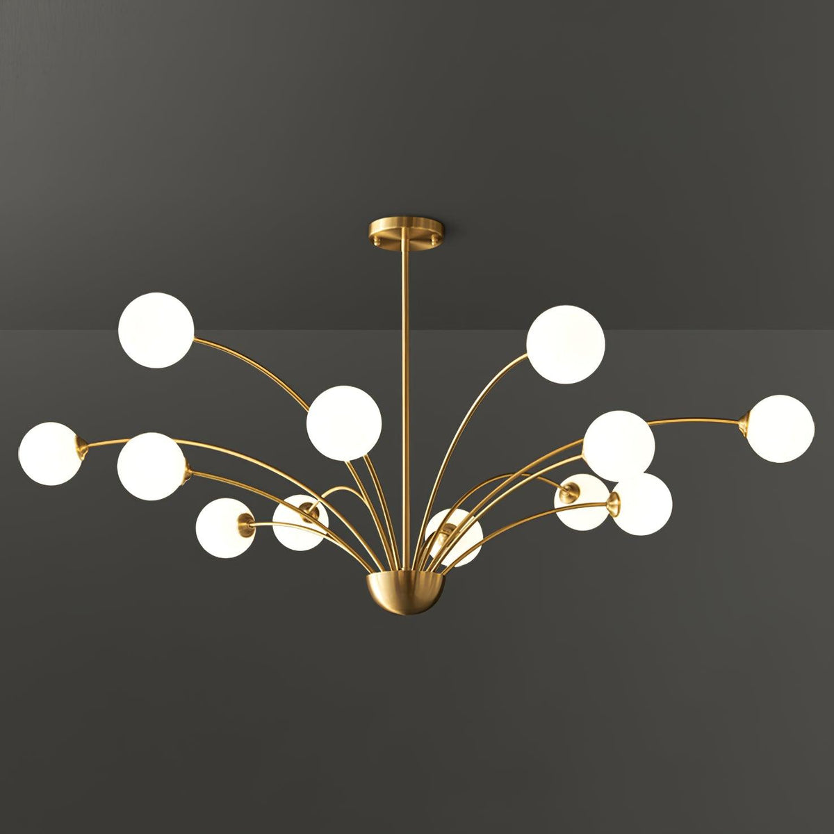 A twelve-globe Clérachic brass chandelier with white glass globes, wide and layered, against a dark grey studio backdrop.