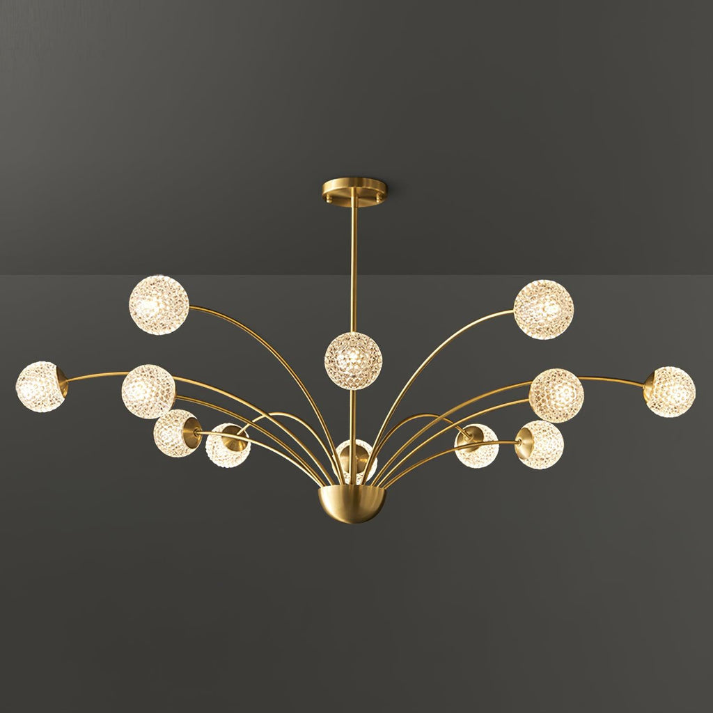 A wide Clérachic brass chandelier with warm, textured globes on layered arms, photographed against a dark grey backdrop.