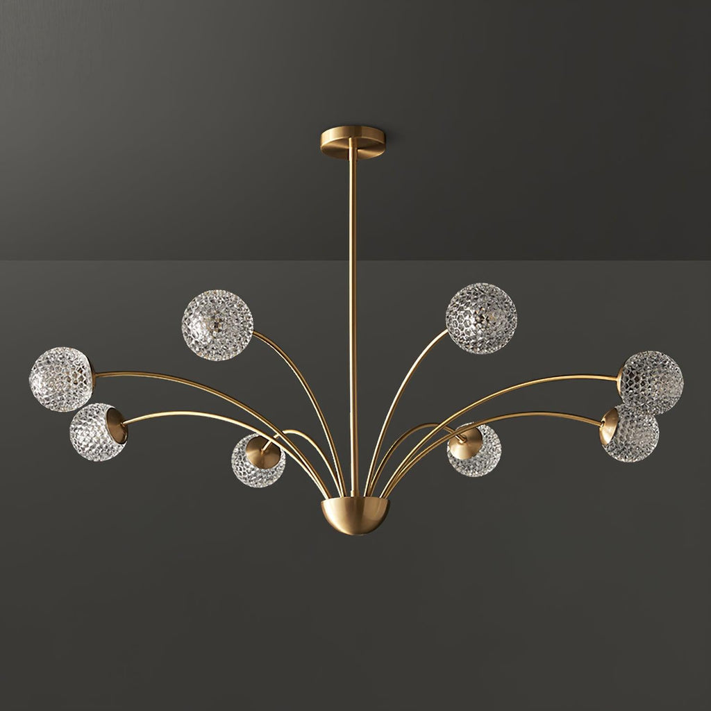 A Clérachic brass chandelier with smoky grey-tinted textured globes, unlit, against a dark grey backdrop.