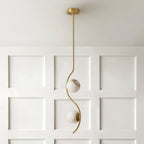 A single Clérachic twin-head pendant drops from a white coffered ceiling in front of a panelled wainscot wall.