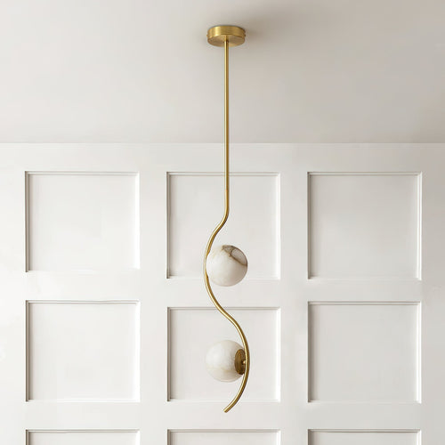 A single Clérachic twin-head pendant drops from a white coffered ceiling in front of a panelled wainscot wall.