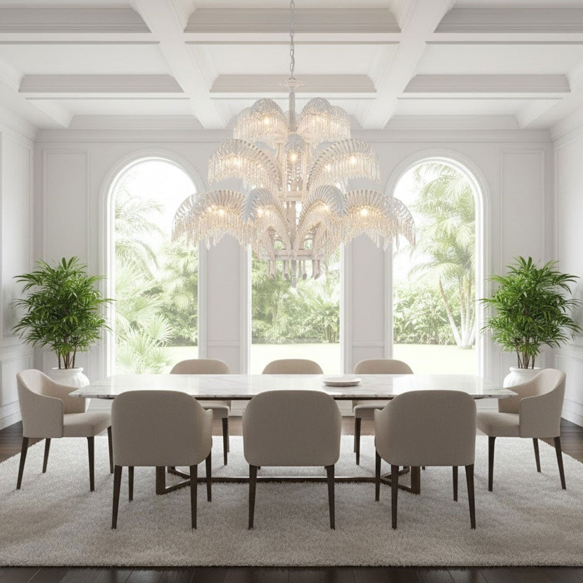 A pale, white-toned Clérachic chandelier hangs in a bright room with three arched windows and a long table with cream chairs.
