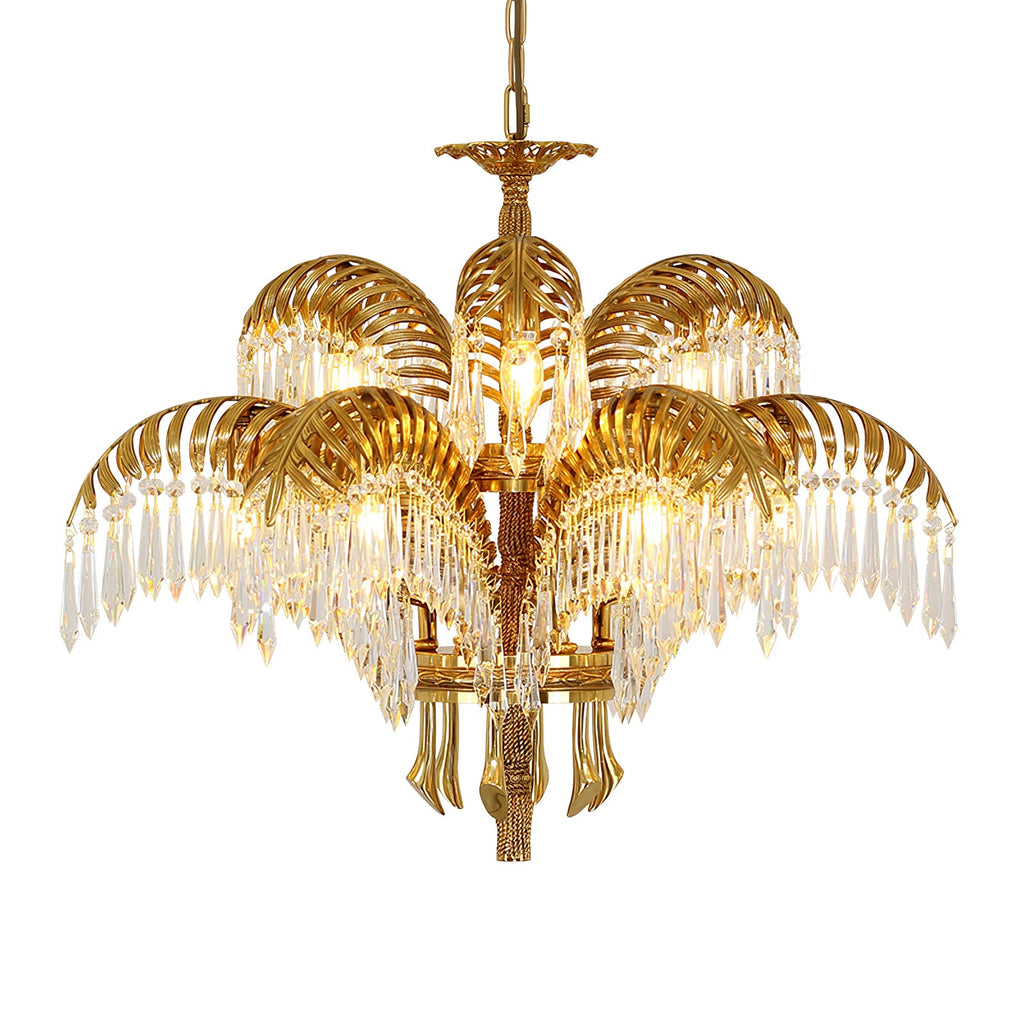 Gold brass palm leaves and crystal drops of this Clérachic chandelier on a white background, with brass tassel-like drops below.