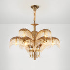 Hung from a bronze ceiling plate on a twisted cover, this Clérachic chandelier shows two tiers of brass leaves and crystal.
