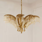 A compact Clérachic brass chandelier with crystal-fringed leaves hangs on a chain against a pale panelled wall.