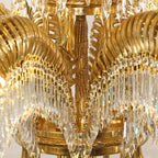 Close view of the carved brass stem and the base ring where the leaves of this Clérachic chandelier meet.