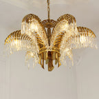 Looking up at this Clérachic chandelier, six brass leaves with crystal fringes rise from a brass base ring.