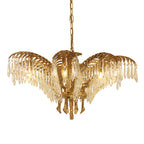 A Clérachic brass chandelier with wide, flat-spread leaves and crystal drops, seen on a white backdrop.