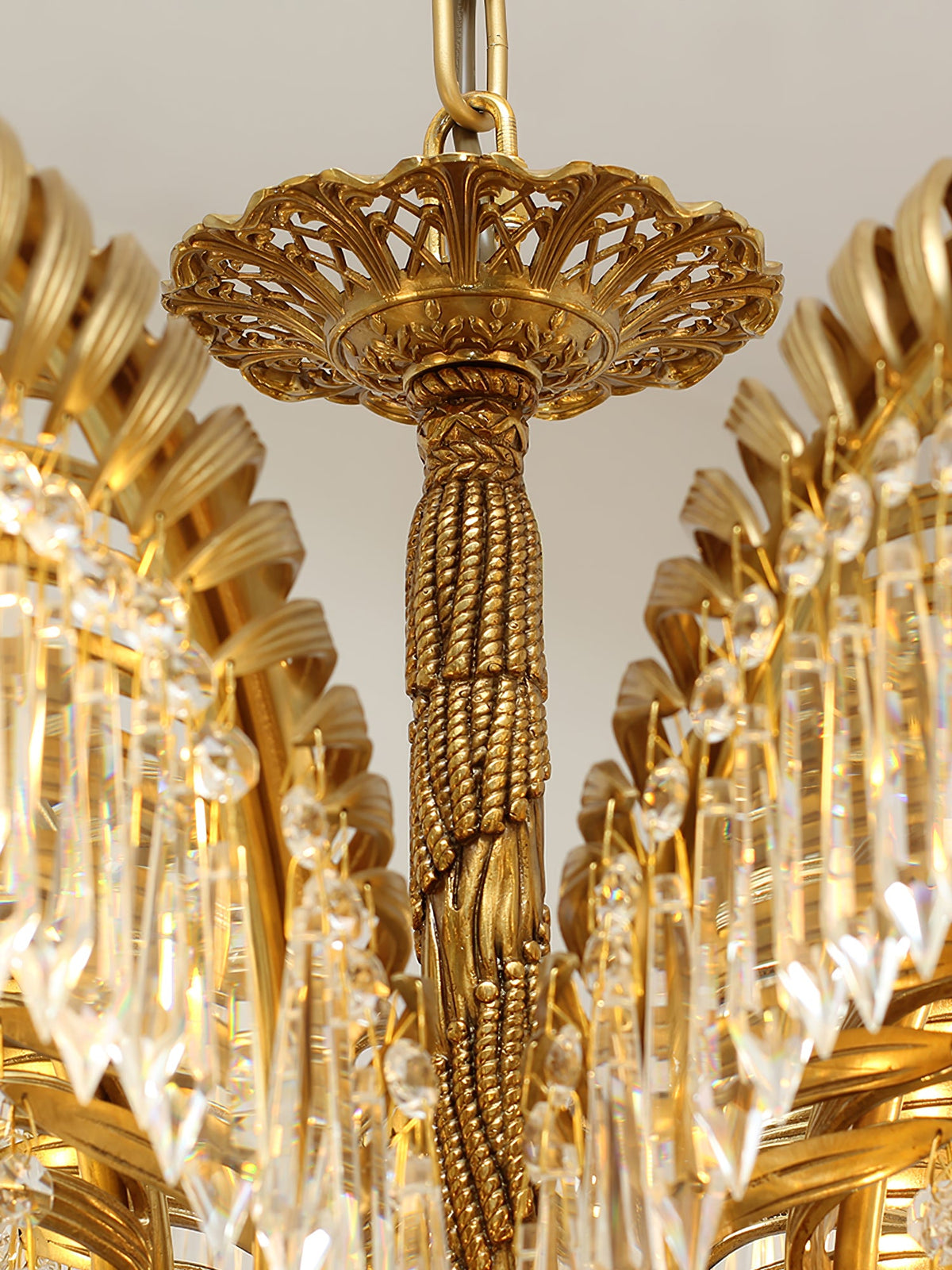 Close view of the pierced brass canopy and twisted rope stem at the top of this Clérachic chandelier.