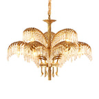 A warmly lit Clérachic chandelier in two tiers, with brass leaves and a cord-wrapped chain, on a white background.
