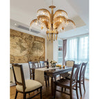 A Clérachic brass chandelier hangs above a dark wooden dining table in a room with a vintage world-map wall.