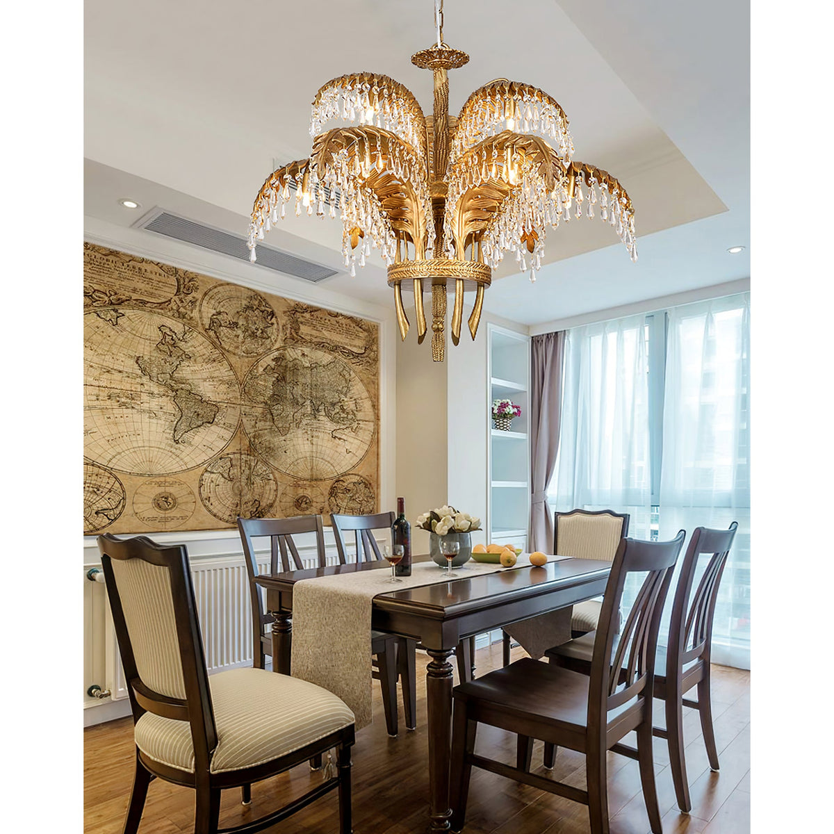 Same room, wider view: a Clérachic brass chandelier hangs over a dining table with a runner and patterned chairs.