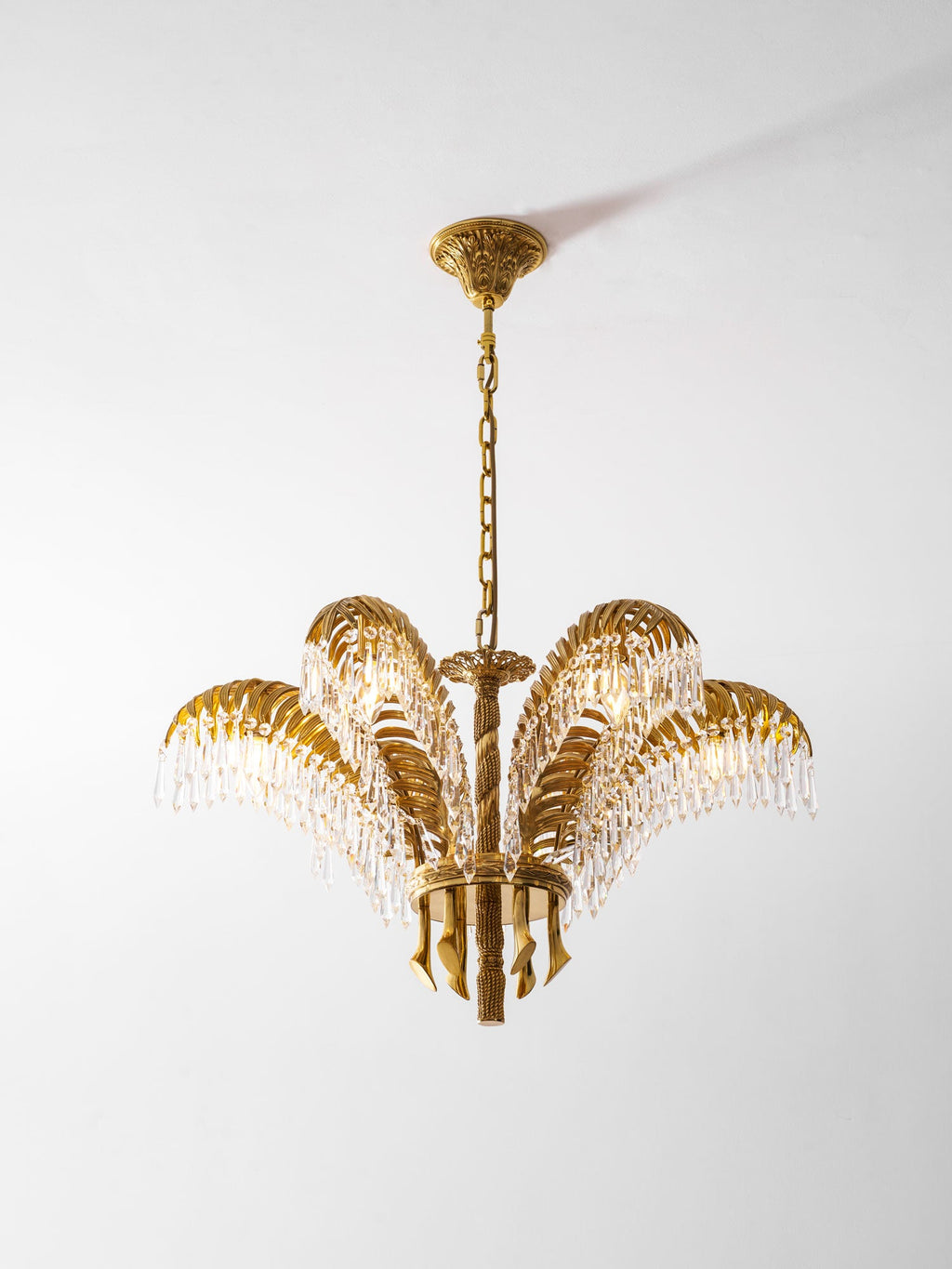Full view of a Clérachic brass chandelier on a gold chain with a ceiling plate, against a light grey background.