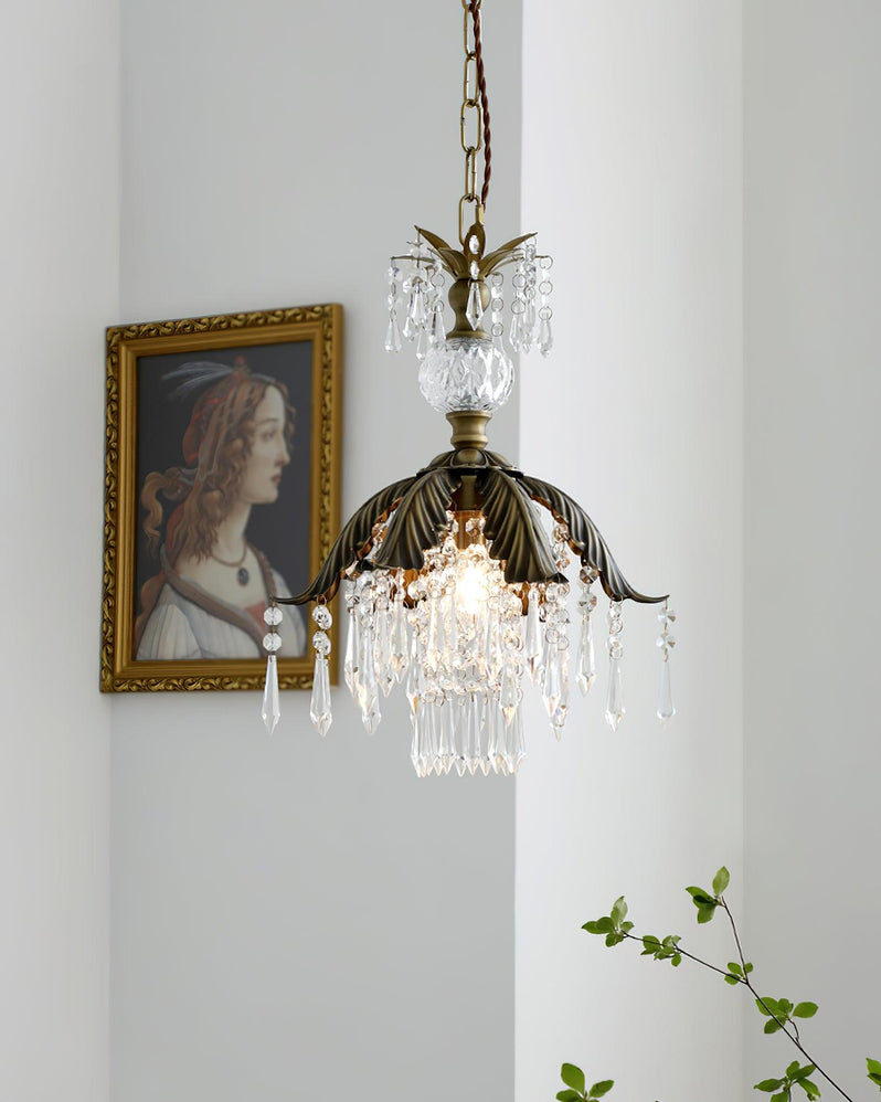 A Clérachic pendant glows beside a portrait in a gilt frame, with a sprig of green leaves in the lower corner.