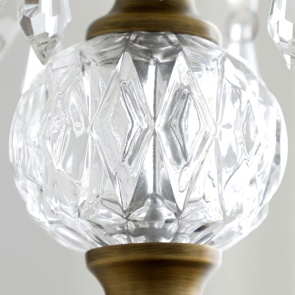 Close view of the faceted clear glass ball between the finial and the bronze canopy on this Clérachic pendant.
