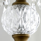 Close view of the faceted clear glass ball between the finial and the bronze canopy on this Clérachic pendant.