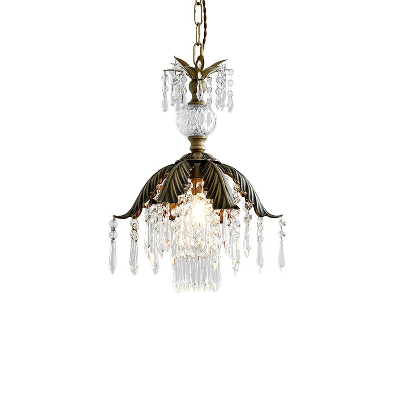 Clérachic pendant with a bronze palm-leaf shade and clear crystal drops, lit and cut out on a white background.