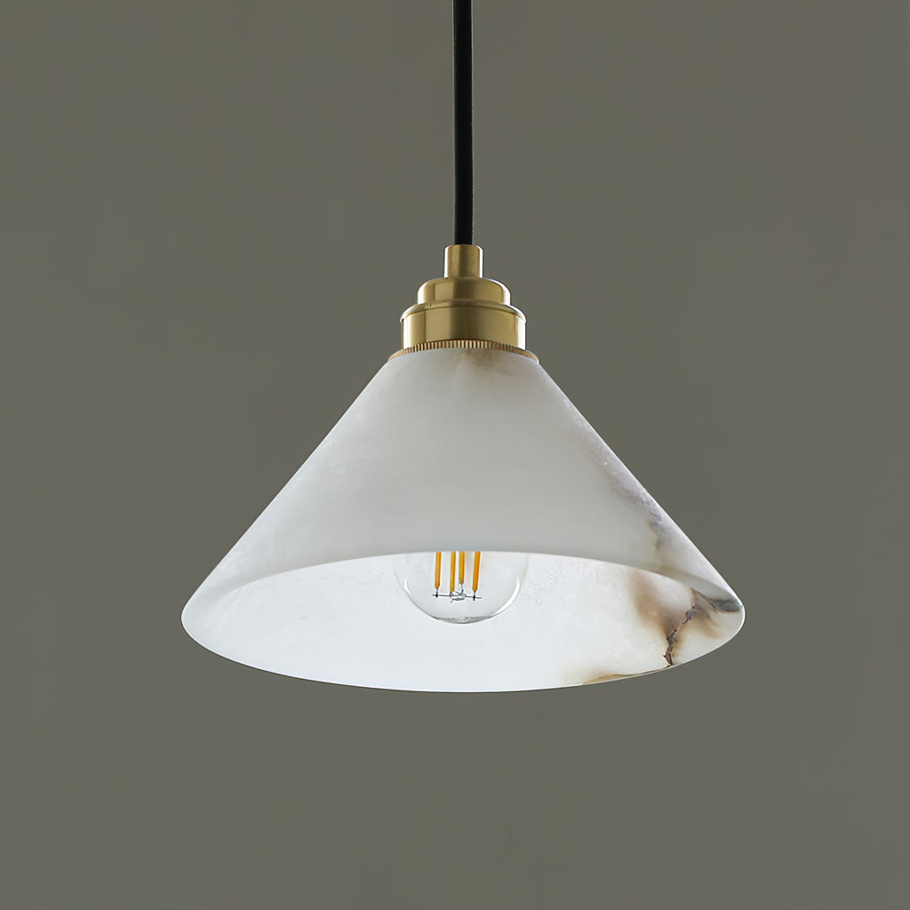 The Clérachic Xen pendant glows on a dark backdrop, its warm filament bulb visible through the translucent alabaster cone.