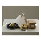 Unboxed Clérachic Xen pendant kit laid out in five parts: alabaster shade, wired socket, ceiling canopy, mounting screws, and bulb box.