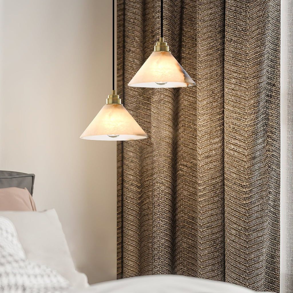 Two Clérachic Xen pendants hang beside a woven brown curtain, warming a bedroom corner near the headboard.