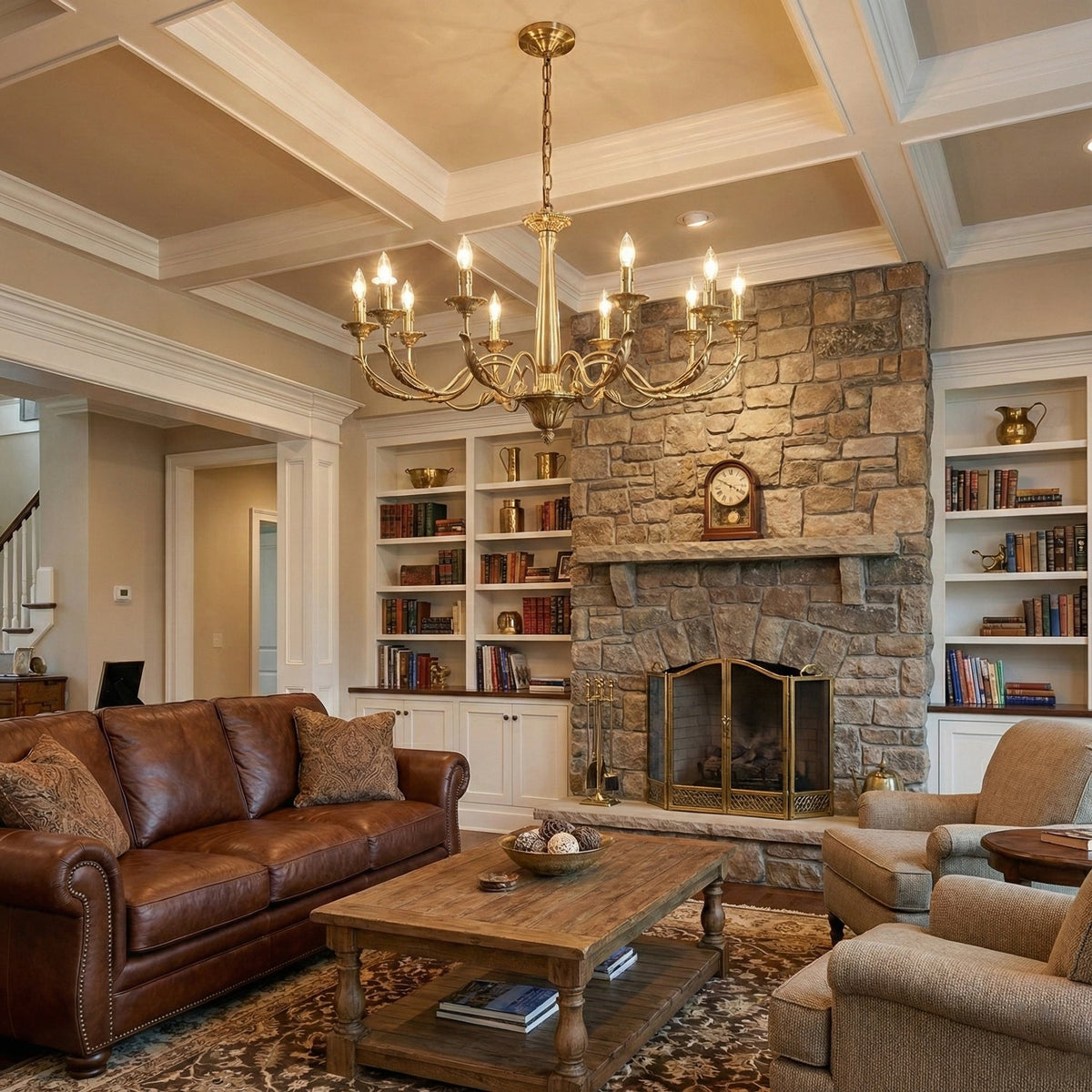 A brass candle-style Clérachic chandelier above a living room with a stone fireplace, built-in shelves and a leather sofa.