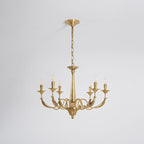 Hung from a chain and a ceiling canopy on a pale backdrop, this six-arm brass candle-style Clérachic chandelier is unlit.