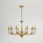 The largest brass candle-style Clérachic chandelier, with ten arms and a long chain, hung against a pale backdrop.