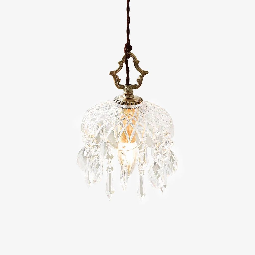 Cut-glass bowl pendant from Clérachic on a white backdrop, with hanging crystal drops, a brass top finial and a twisted dark cord.