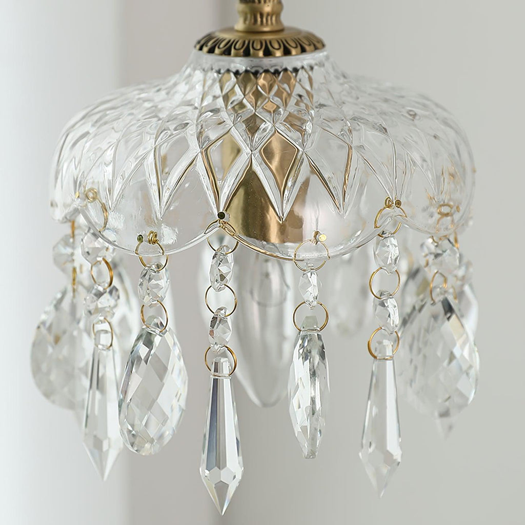 Close view of the brass collar, the diamond-cut glass bowl and the faceted crystal drops on this Clérachic pendant.