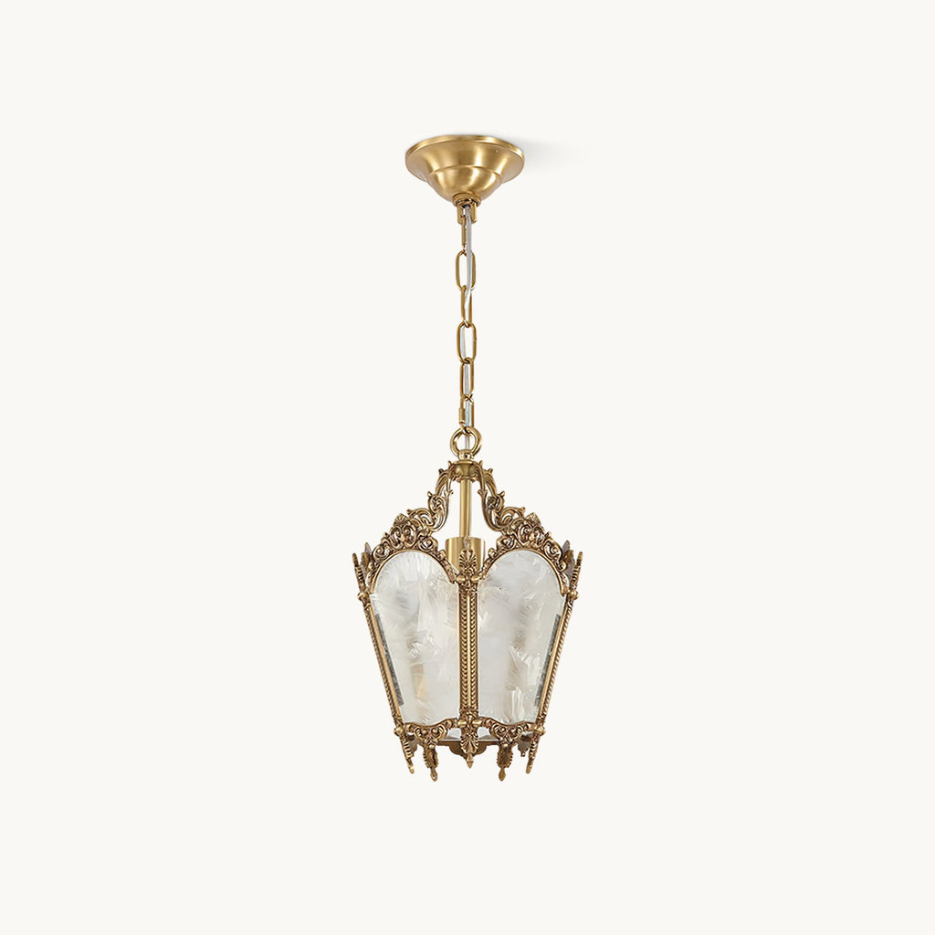 On a plain white backdrop, a Clérachic lantern pendant with an ornate brass frame, frosted glass panels and a slim hanging chain.