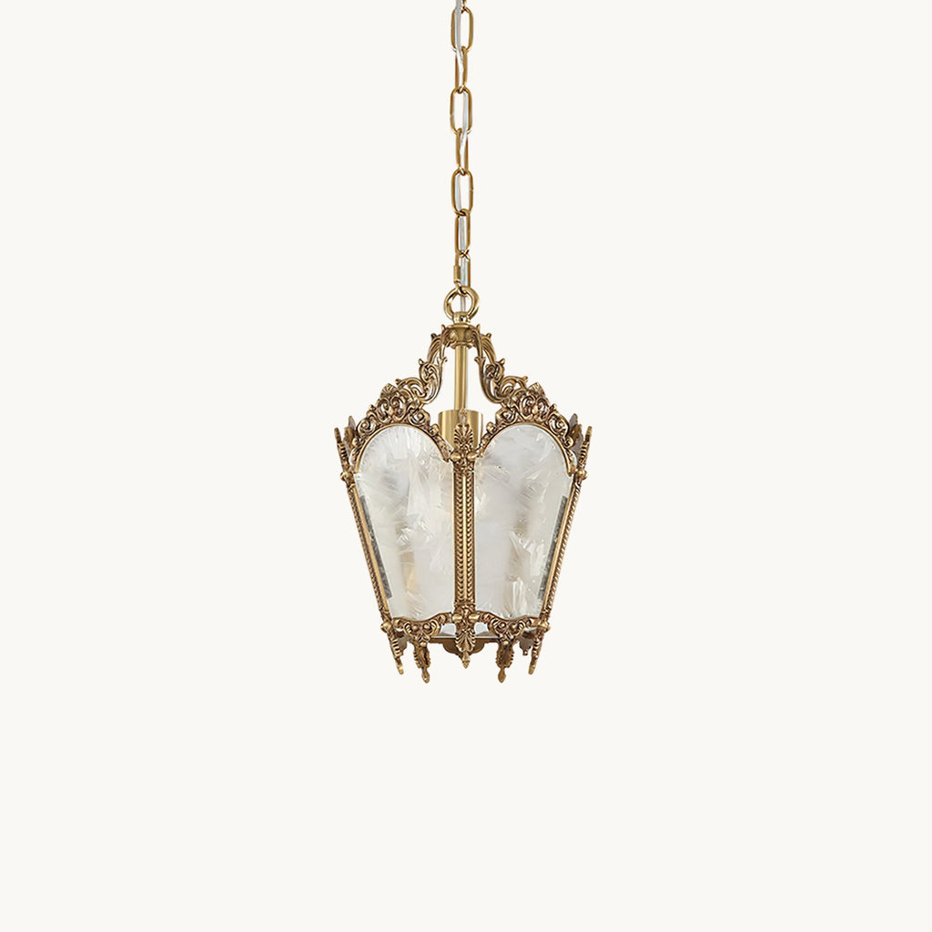 A small Clérachic lantern pendant with an ornate brass top, frosted panels and a thin chain, hanging on a pale cream backdrop.