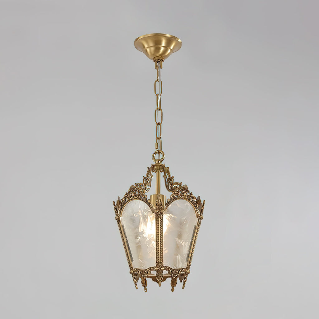 A Clérachic lantern pendant with a round brass ceiling cap and a fine chain hangs on a pale grey backdrop.