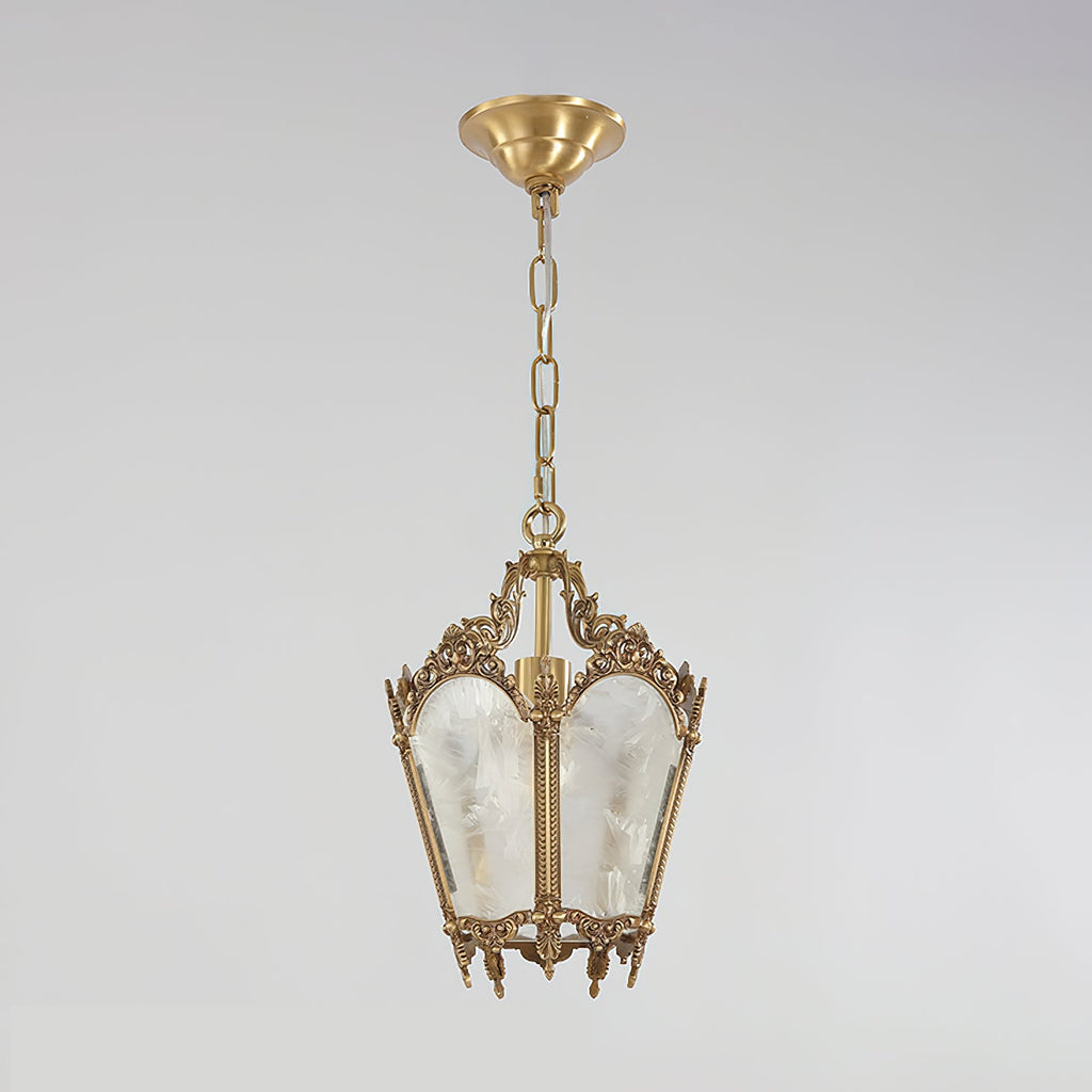 A Clérachic lantern pendant with a brass canopy, a chain and frosted glass panels hangs against a soft grey backdrop.