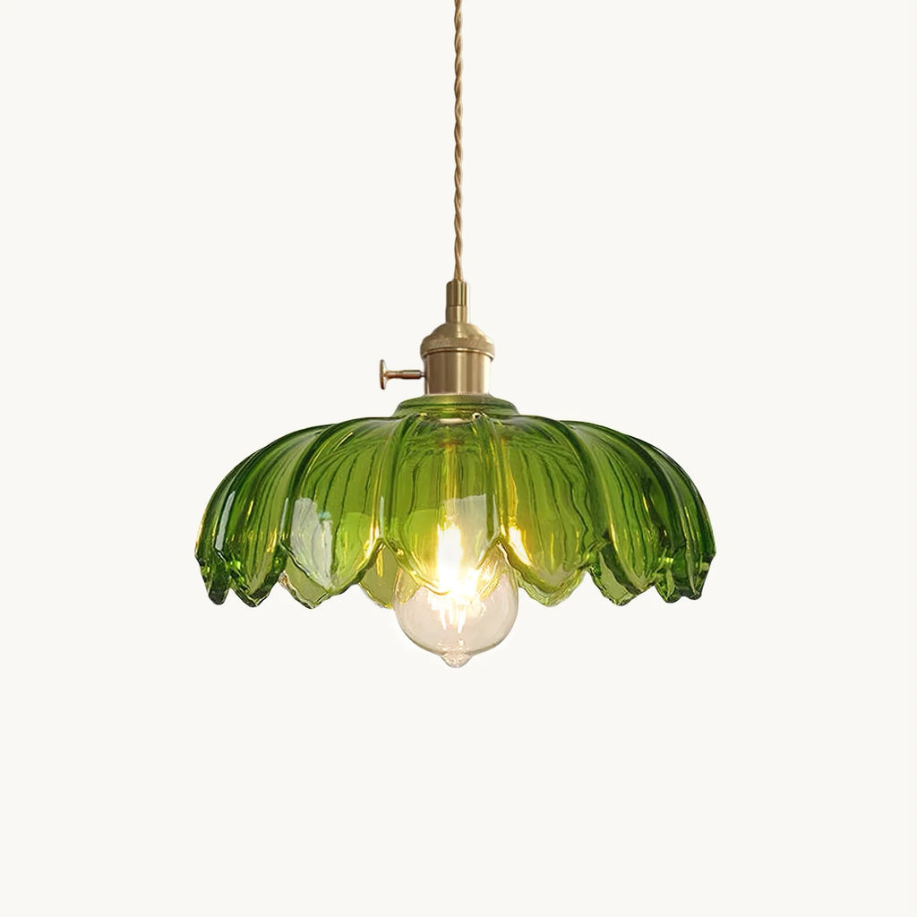 Green glass pendant with a petal-edged shade, brass fitting with a small switch and a twisted cord, from Clérachic on a plain backdrop.