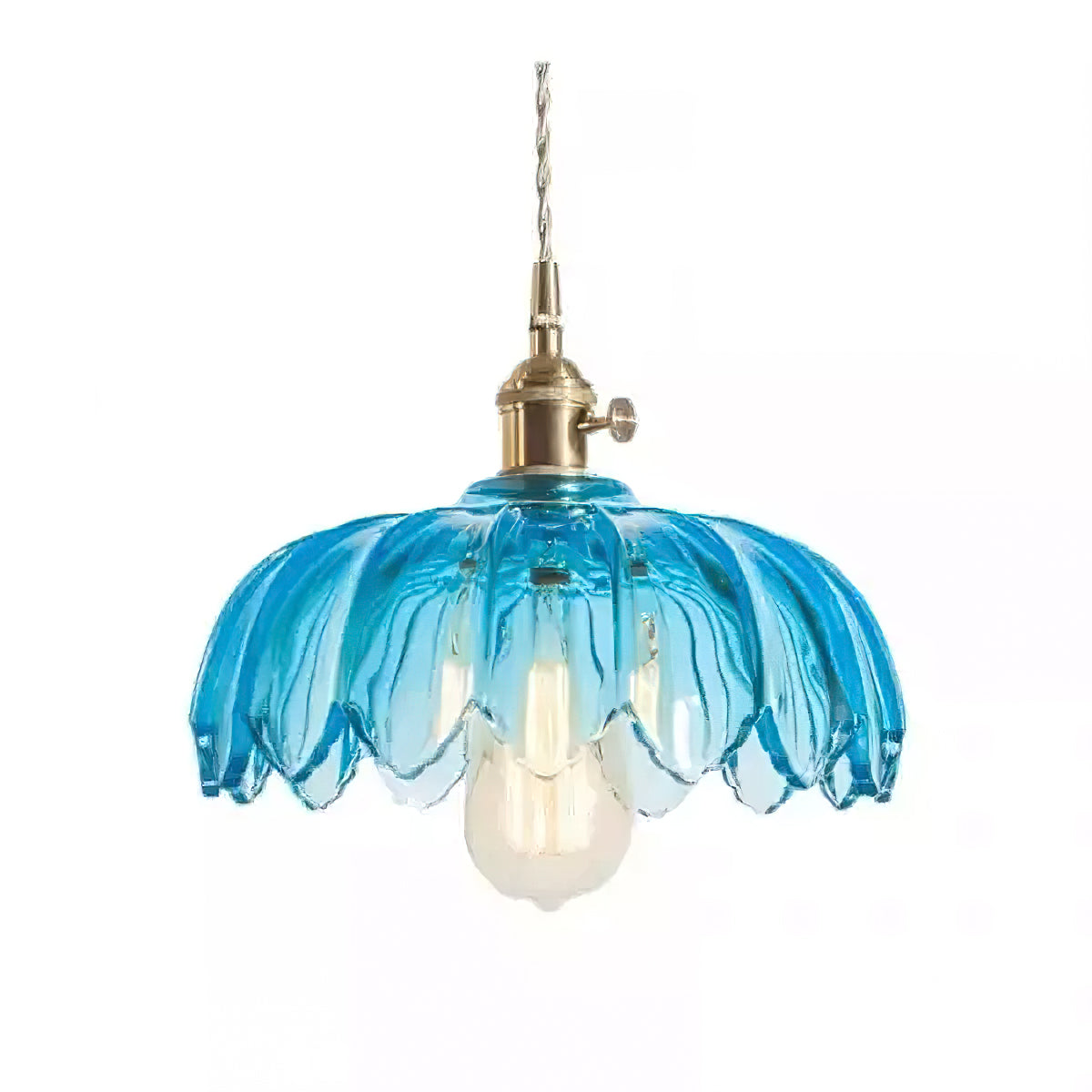 Blue glass Clérachic pendant with a petal-edged shade, a brass switch fitting and a warm bulb, on a plain white backdrop.