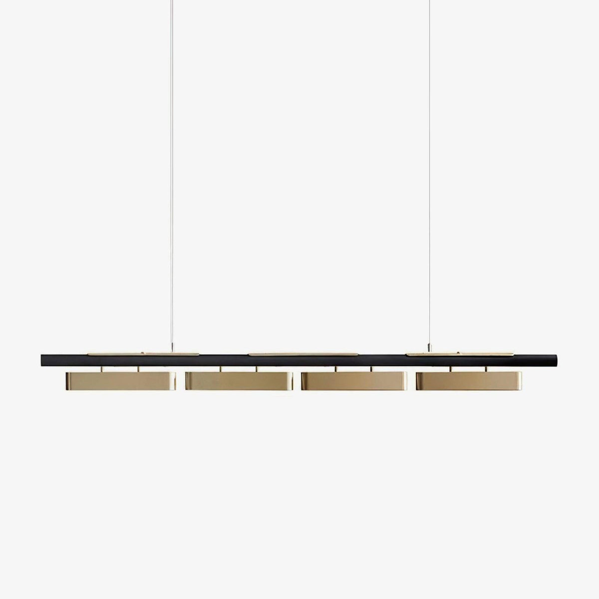 A Clérachic linear pendant with a slim black bar and four brass-toned diffusers, hung on two thin wires against a plain white backdrop.