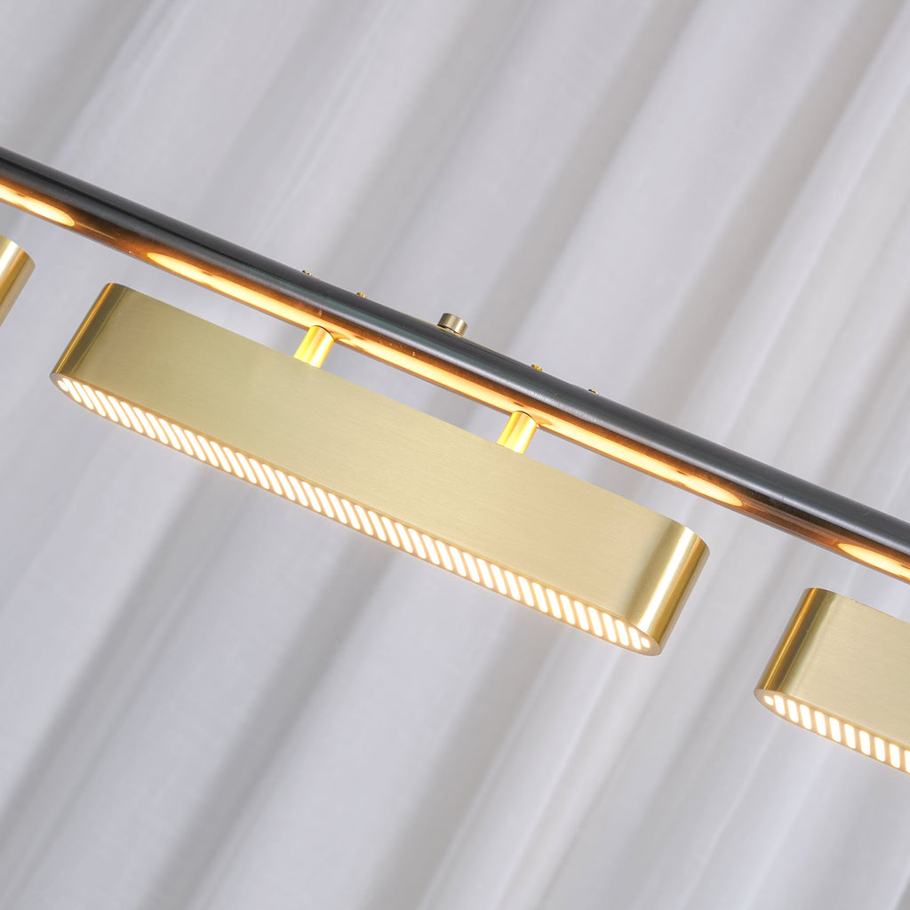 Close view of a brass diffuser on this Clérachic linear pendant, showing the fine ribbed lens along its underside and the black bar above.