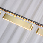 Close view of a brass diffuser on this Clérachic linear pendant, showing the fine ribbed lens along its underside and the black bar above.